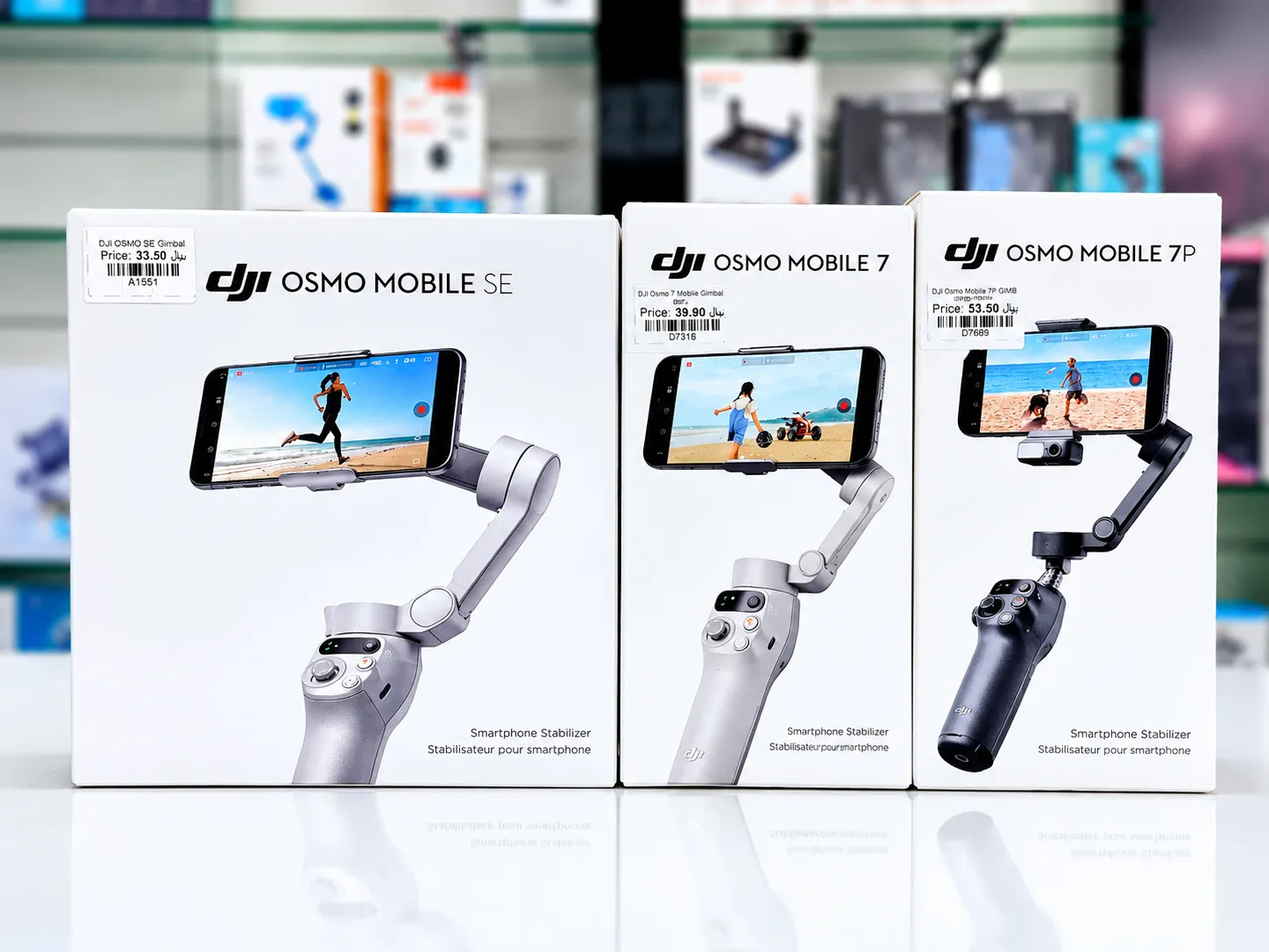Boxed DJI Osmo Mobile smartphone gimbal stabilizers in Oman on display at Sky Gadgets, including Osmo Mobile SE, Osmo Mobile 7, and Osmo Mobile 7P
