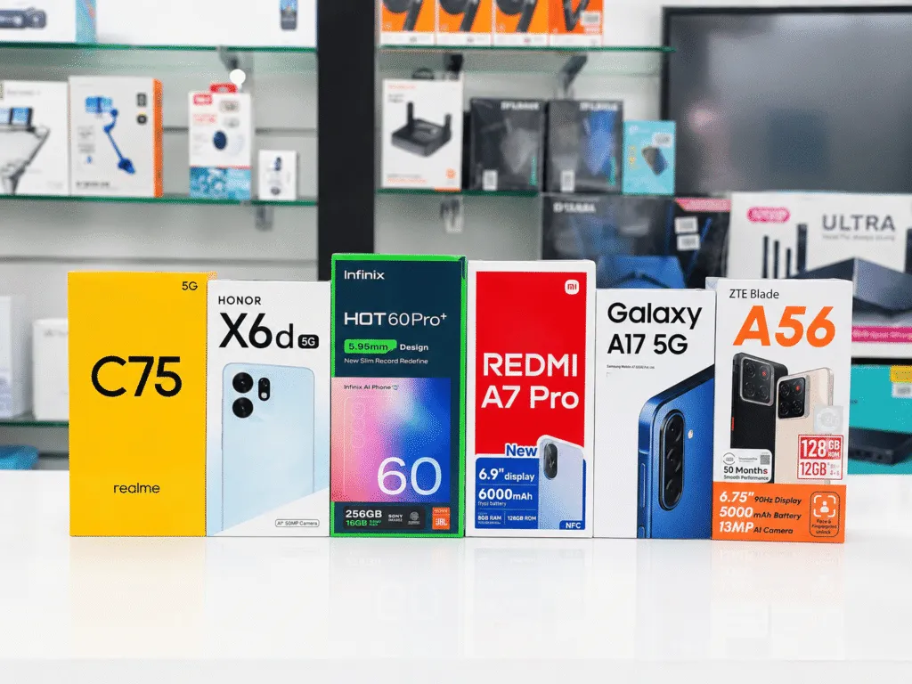 Boxed mobile phones in Oman on display at Sky Gadgets, including realme C75, Honor X6d, Infinix Hot 60 Pro+, Redmi A7 Pro, Galaxy A17 5G, and ZTE Blade A56