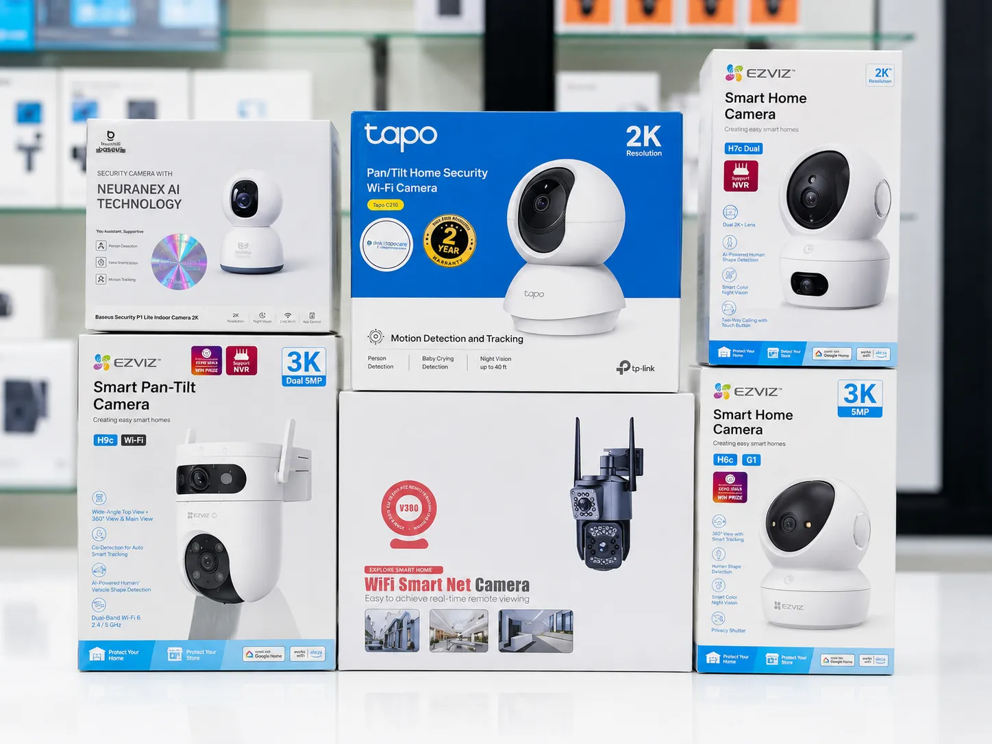 Boxed smart home security cameras in Oman on display at Sky Gadgets, including Baseus, TP-Link Tapo, EZVIZ, and V380 cameras