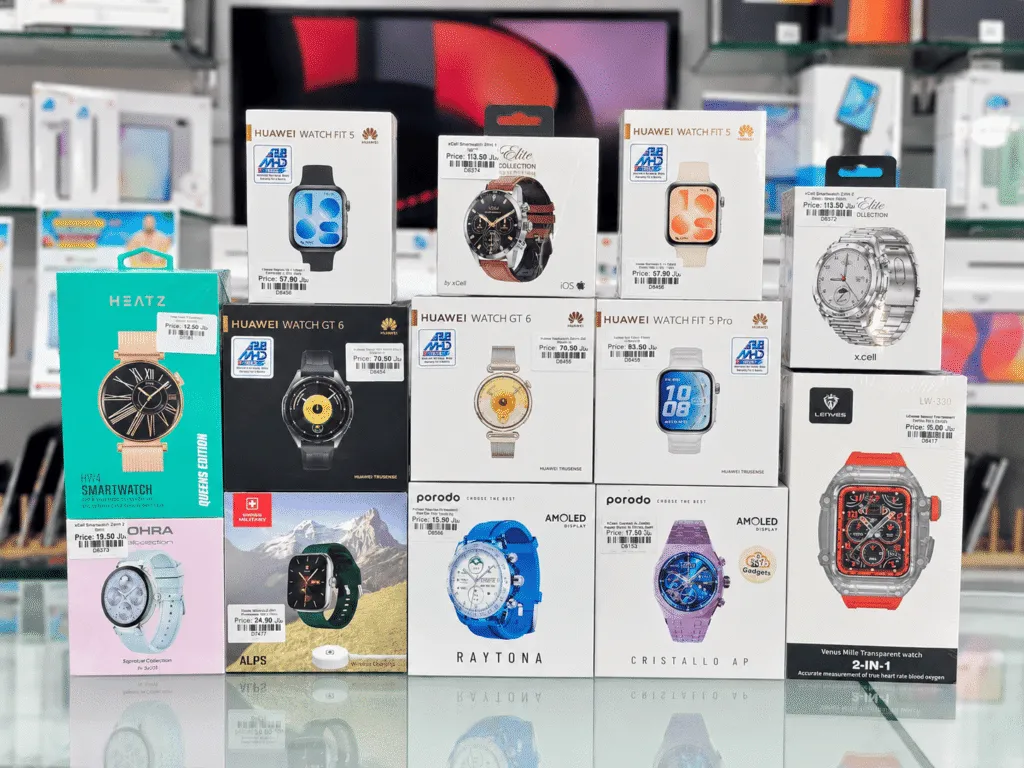 Boxed smartwatches in Oman on display at Sky Gadgets, including Huawei Watch Fit 5, Huawei Watch GT 6, xCell Elite Collection, and Porodo AMOLED smartwatches